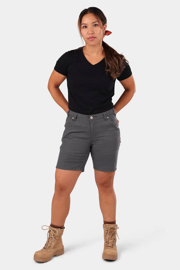 GO TO™ Stretch Canvas Short in Cement Grey by Dovetail Workwear, worn by a woman with hands on hips, paired with tan lace-up boots