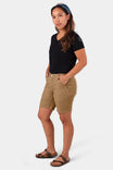 Sawdust Brown GO TO™ Stretch Canvas Shorts by Dovetail Workwear worn by a woman, showcasing the mid-rise fit, 7.5" inseam, and functional pockets from a side angle