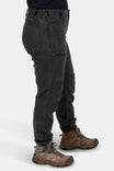 Side view of a woman wearing Dovetail Workwear's Provisions Lightweight Ripstop Cargo Pant in Faded Black, featuring multiple cargo pockets and a relaxed leg fit