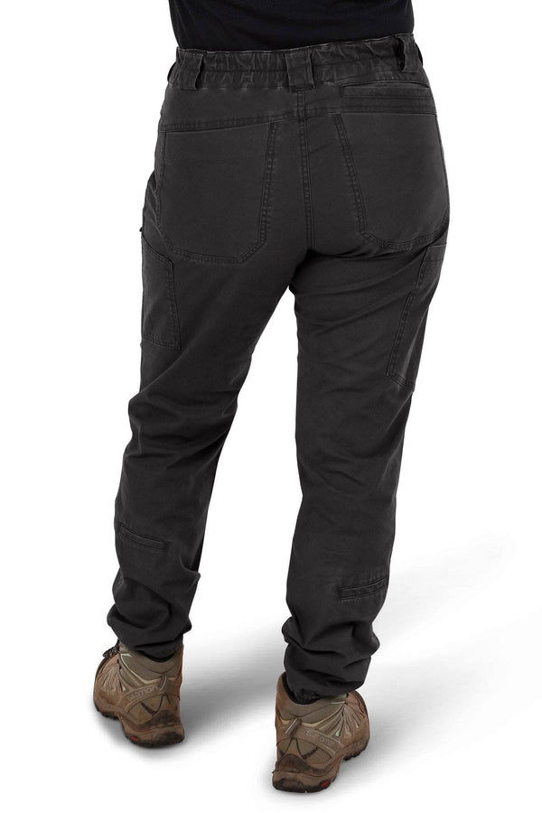 Back view of a woman wearing Dovetail Workwear's Provisions Lightweight Ripstop Cargo Pant in Faded Black, showing cargo pockets and relaxed leg fit with hiking boots