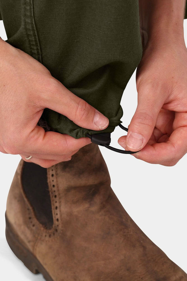 Detail shot of a woman adjusting the elastic waist and drawcord cuff of the Dovetail Workwear Provisions Lightweight Ripstop Cargo Pant in Moss Green