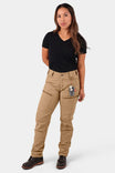 Woman wearing Dovetail Workwear Provisions Lightweight Ripstop Cargo Pant in Tan Sandstone with black v-neck t-shirt, showcasing cargo pockets and relaxed fit