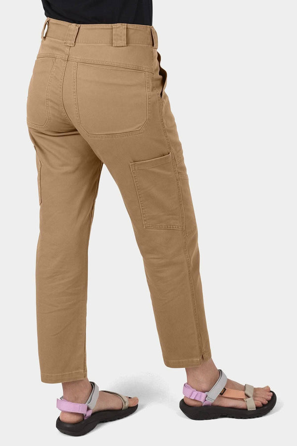 Back view of a woman wearing Dovetail Workwear's Range Crop Pant in Sawdust Brown, showcasing the bellowed front pockets and relaxed leg fit