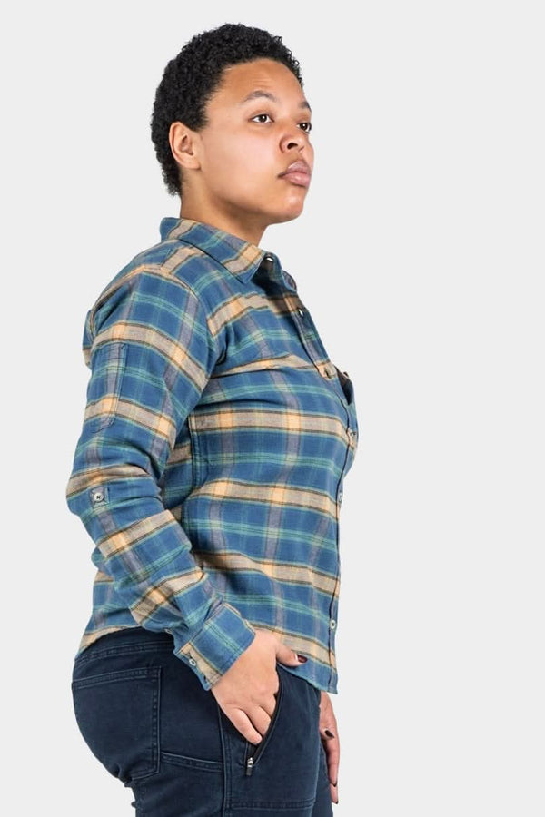 Side view of a woman wearing the Givens Work Shirt in Stretch Flannel in Coffee and Vintage Blue Plaid by Dovetail Workwear, featuring a plaid pattern, chest pocket, and cuff tabs