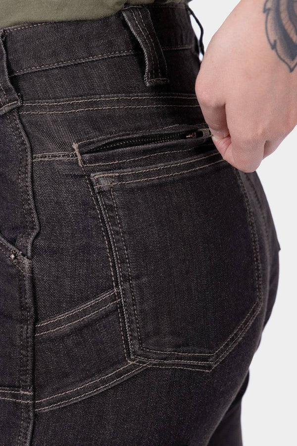 Close-up detail of the back pocket and Hip Slot™ tool loop on Dovetail Workwear's Old School High Rise Graphene Denim Pant in Heather Black, worn by a woman