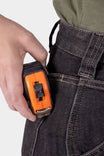 Woman holding an orange utility tool at the Hip Slot™ of Dovetail Workwear's Old School High Rise Graphene Denim Pant in Heather Black