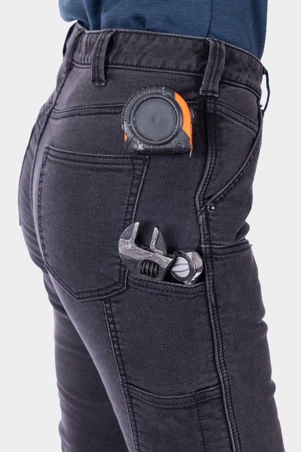 Close-up of Dovetail Workwear Britt Utility HOTSWAP™ Pant in Black Thermal Denim showing tool loop with wrench and tape measure in hip pocket