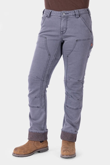 Dovetail Workwear Britt Utility HOTSWAP™ Pant in Grey Thermal Denim worn by a woman, featuring cargo-style pockets, articulated knees, and Tough Cuff™ with thermal lining