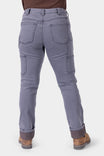Back view of a woman wearing Dovetail Workwear's Britt Utility HOTSWAP™ Pant in Grey Thermal Denim, featuring cargo-style pockets, tool loops, and Tough Cuff™ with thermal lining