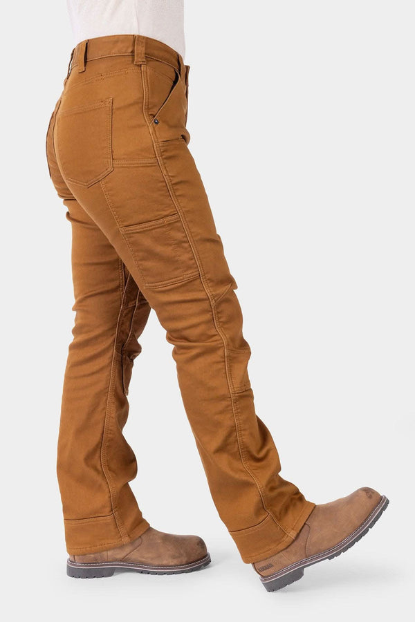 Side view of a woman wearing the Britt Utility HOTSWAP™ Pant in Saddle Brown Thermal Denim by Dovetail Workwear, showing cargo-style pockets, tool loop, and straight leg silhouette