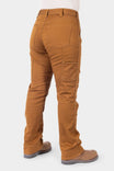 Back view of a woman wearing Dovetail Workwear's Britt Utility HOTSWAP™ Pant in Saddle Brown Thermal Denim, highlighting cargo-style pockets, straight leg fit, and thermal denim construction