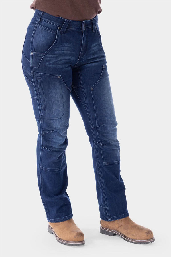 Indigo Britt X Graphene Denim Pant by Dovetail Workwear featuring cargo-style pockets, reinforced panels, and articulated knees, shown on a woman from waist down