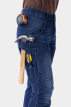 Dovetail Workwear Britt X Graphene Denim Pant in indigo worn by a woman with tools in cargo pockets and belt loops, showing durability and functionality