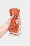 Dovetail Workwear Carver Wool Wild Rag Bandana in Paprika held up by a woman's hand, showing the soft wool texture and dove print design against a white background