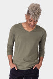 Dovetail Workwear GO TO™ Long Sleeve V-Neck T-Shirt in Kelp Green, shown on a woman looking down with hands in pockets, featuring a relaxed fit and 100% cotton construction