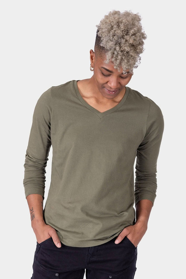 Dovetail Workwear GO TO™ Long Sleeve V-Neck T-Shirt in Kelp Green, shown on a woman looking down with hands in pockets, featuring a relaxed fit and 100% cotton construction
