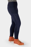 Side view of a woman wearing Dovetail Workwear Field Utility Legging in Black with visible zip side pocket and crotch gusset, paired with brown work boots