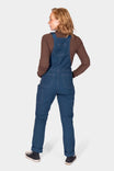 Back view of a woman wearing Dovetail Workwear GO TO™ Stretch Canvas Overalls in Atlantic Blue with reinforced knees and nested pockets