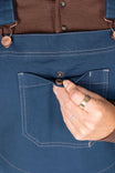 Close-up detail of the GO TO™ Stretch Canvas Overalls in Atlantic Blue by Dovetail Workwear, showing the phone pocket and copper snap hardware on the bib