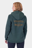 Back view of a woman wearing the Dovetail Workwear GO TO™ Graphic Hoodie in Lodge Green, featuring a graphic on the back and reinforced elbows