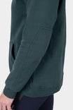 Side view of a woman wearing the Dovetail Workwear GO TO™ Graphic Hoodie in Lodge Green, showing the reinforced elbow detail and ribbed cuff