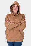 Saddle Brown GO TO™ Graphic Hoodie by Dovetail Workwear worn by a woman with arms crossed, featuring reinforced elbows and front kangaroo pocket