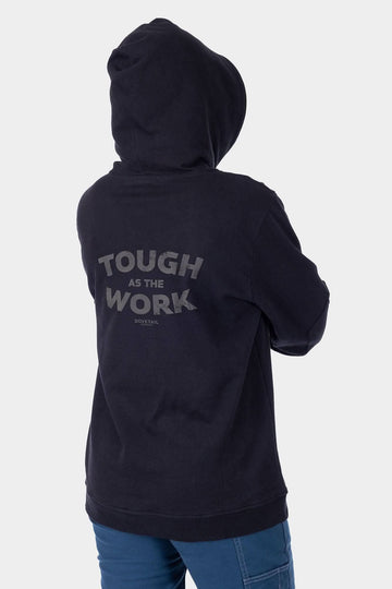Back view of a woman wearing the Dovetail Workwear GO TO™ Graphic Hoodie in Carbon Black, featuring graphic text and reinforced elbows