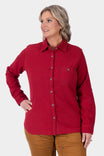Dovetail Workwear Givens Stretch Chamois Work Shirt in Barn Red worn by a woman, featuring a buttoned chest pocket, long sleeves with cuff tabs, and paired with tan work pants