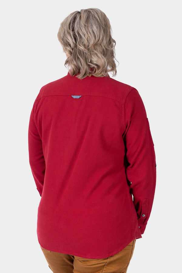 Back view of a woman wearing the Givens Stretch Chamois Work Shirt in Barn Red by Dovetail Workwear, showcasing the locker loop detail