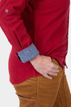 Side view of a woman wearing the Barn Red Givens Stretch Chamois Work Shirt by Dovetail Workwear, showing the cuff tab detail and pencil pocket on the sleeve