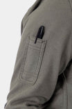 Detail view of the pencil pocket on the sleeve of the Givens Stretch Chamois Work Shirt by Dovetail Workwear, shown in Patina Green with a pen inserted
