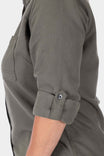 Close-up of the cuff detail on the Givens Stretch Chamois Work Shirt by Dovetail Workwear, showing the cuff tab and rolled sleeve on a woman wearing the shirt in Patina Green
