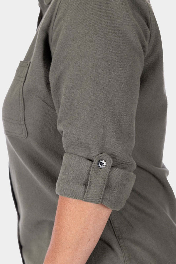 Close-up of the cuff detail on the Givens Stretch Chamois Work Shirt by Dovetail Workwear, showing the cuff tab and rolled sleeve on a woman wearing the shirt in Patina Green