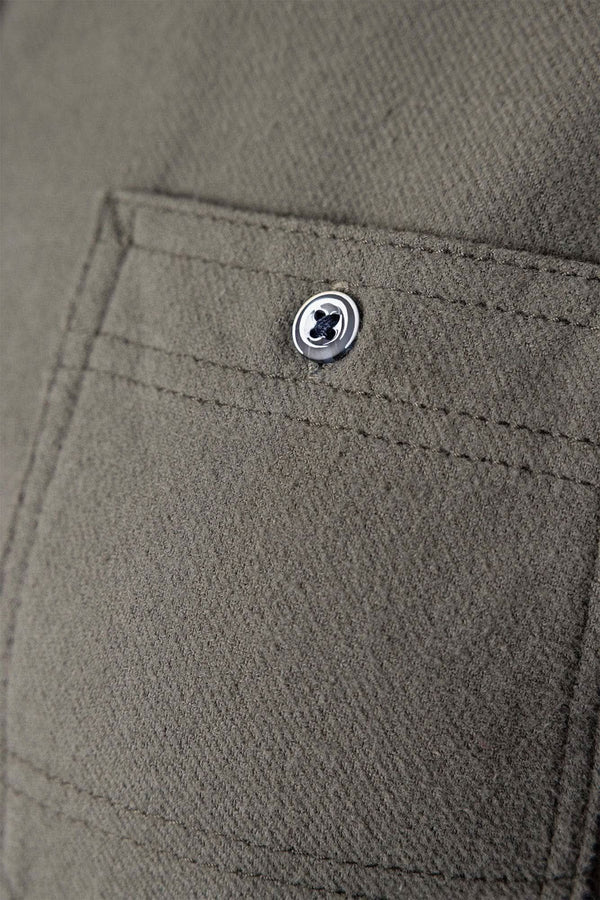 Close-up detail of the buttoned chest pocket on the Givens Stretch Chamois Work Shirt in Patina Green