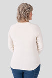Back view of a woman wearing the Dovetail Workwear Honed Long Sleeve Thermal Henley in Oatmeal with dark jeans, showcasing the waffle knit fabric and reinforced elbows.