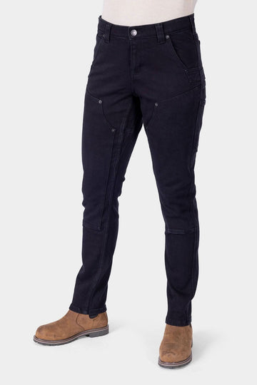 Black Maven X Graphene Denim Pant by Dovetail Workwear shown on a woman, featuring reinforced pockets, crotch gusset, and slim-leg carpenter styling with tan boots