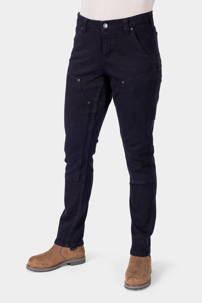 Black Maven X Graphene Denim Pant by Dovetail Workwear shown on a woman, featuring reinforced pockets, crotch gusset, and slim-leg carpenter styling with tan boots