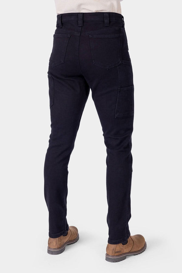 Back view of a woman wearing Dovetail Workwear's Maven X Graphene Denim Pant in black, showing the slim leg fit, and reinforced construction
