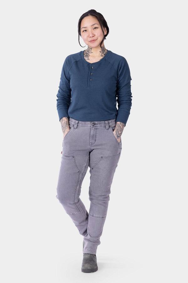 Maven X HOTSWAP™ Thermal Denim Pant in grey by Dovetail Workwear, shown on a woman wearing a navy henley, featuring slim fit and reinforced front pockets