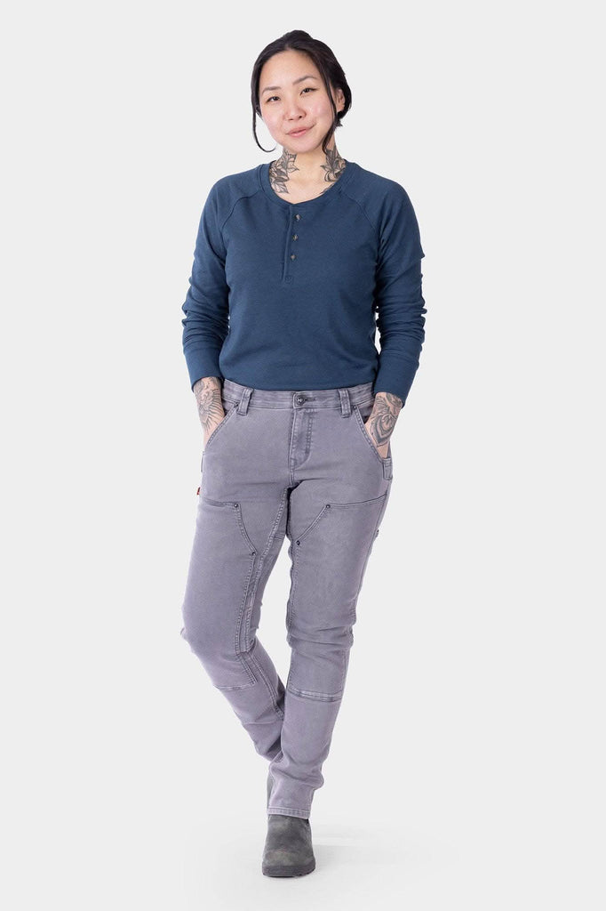 Maven X HOTSWAP™ Thermal Denim Pant in grey by Dovetail Workwear, shown on a woman wearing a navy henley, featuring slim fit and reinforced front pockets