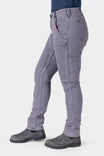 Side view of a woman wearing Dovetail Workwear's Maven X HOTSWAP™ Thermal Denim Pant in grey, featuring visible pockets and reinforced seams