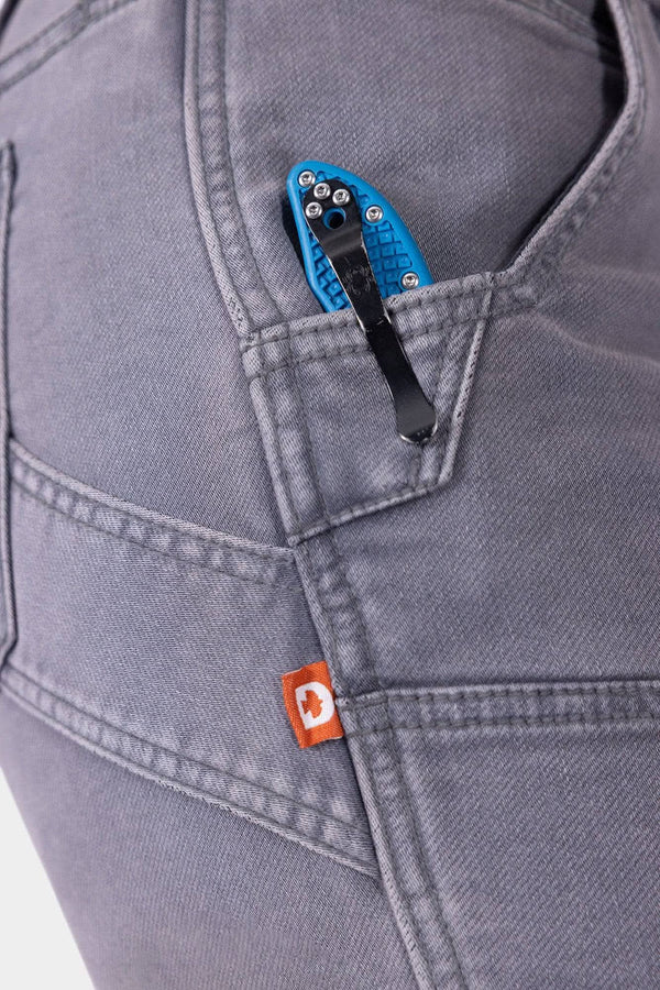 Close-up detail of the Maven X HOTSWAP™ Thermal Denim Pant in Grey by Dovetail Workwear, showing the Hip Slot™ feature with thermal insert and brand label on pocket