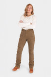 Dovetail Workwear Old School High Rise Work Pant in Beechwood Brown Denim worn by a woman with arms crossed, featuring visible Hip Slot™ Zip pocket, tool loops, knee pad slots, and reinforced construction