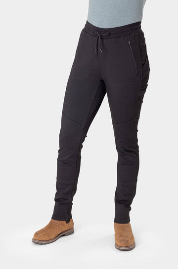 Front view of a woman wearing the Christa X DIY Pant in Black Performance Modal, featuring reinforced knees and front zip pockets