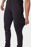 Back view of a woman wearing the Christa X DIY Pant in Black Performance Modal by Dovetail Workwear, highlighting reinforced knees and articulated design