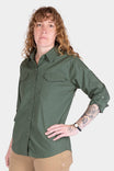 Woman wearing the Aventurine Green AJ COOLSWAP™ Work Shirt by Dovetail Workwear, featuring buttoned chest pockets and ultra-lightweight ripstop fabric for active work