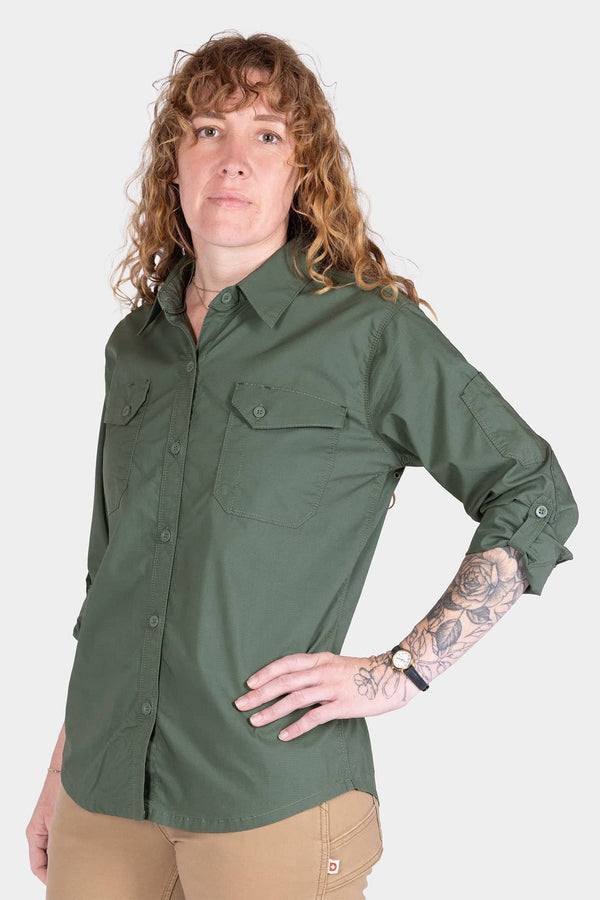 Woman wearing the Aventurine Green AJ COOLSWAP™ Work Shirt by Dovetail Workwear, featuring buttoned chest pockets and ultra-lightweight ripstop fabric for active work