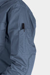 Detail shot of the AJ COOLSWAP™ Work Shirt in Dovetail Blue, highlighting the buttoned chest pocket and armpit vent for breathability