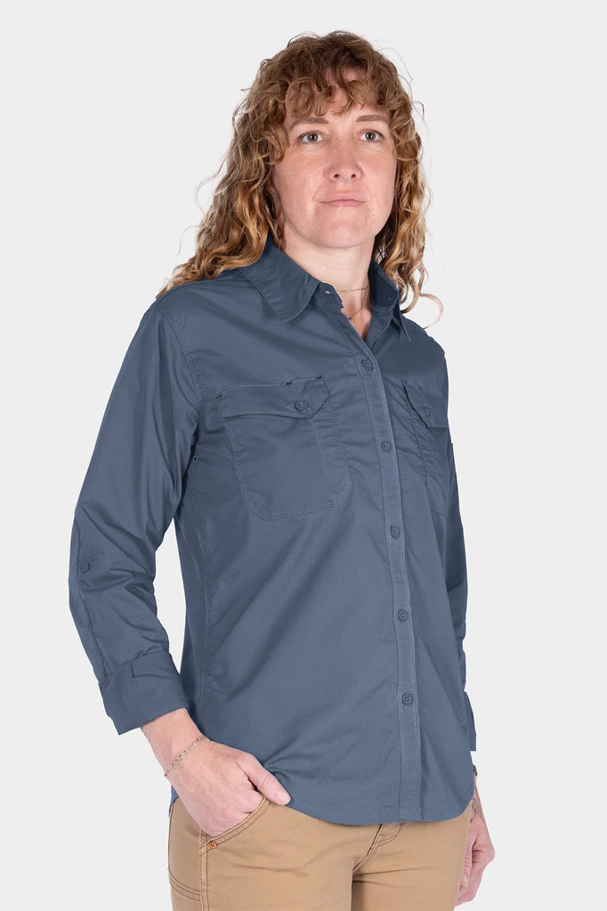 Dovetail Workwear AJ COOLSWAP™ Work Shirt in Dovetail Blue worn by a woman, featuring visible chest pockets, button front, and armpit vents for cooling breathability