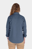Back view of a woman wearing the Dovetail Workwear AJ COOLSWAP™ Work Shirt in Dovetail Blue with khaki pants, showcasing the back vent and shirt's relaxed fit